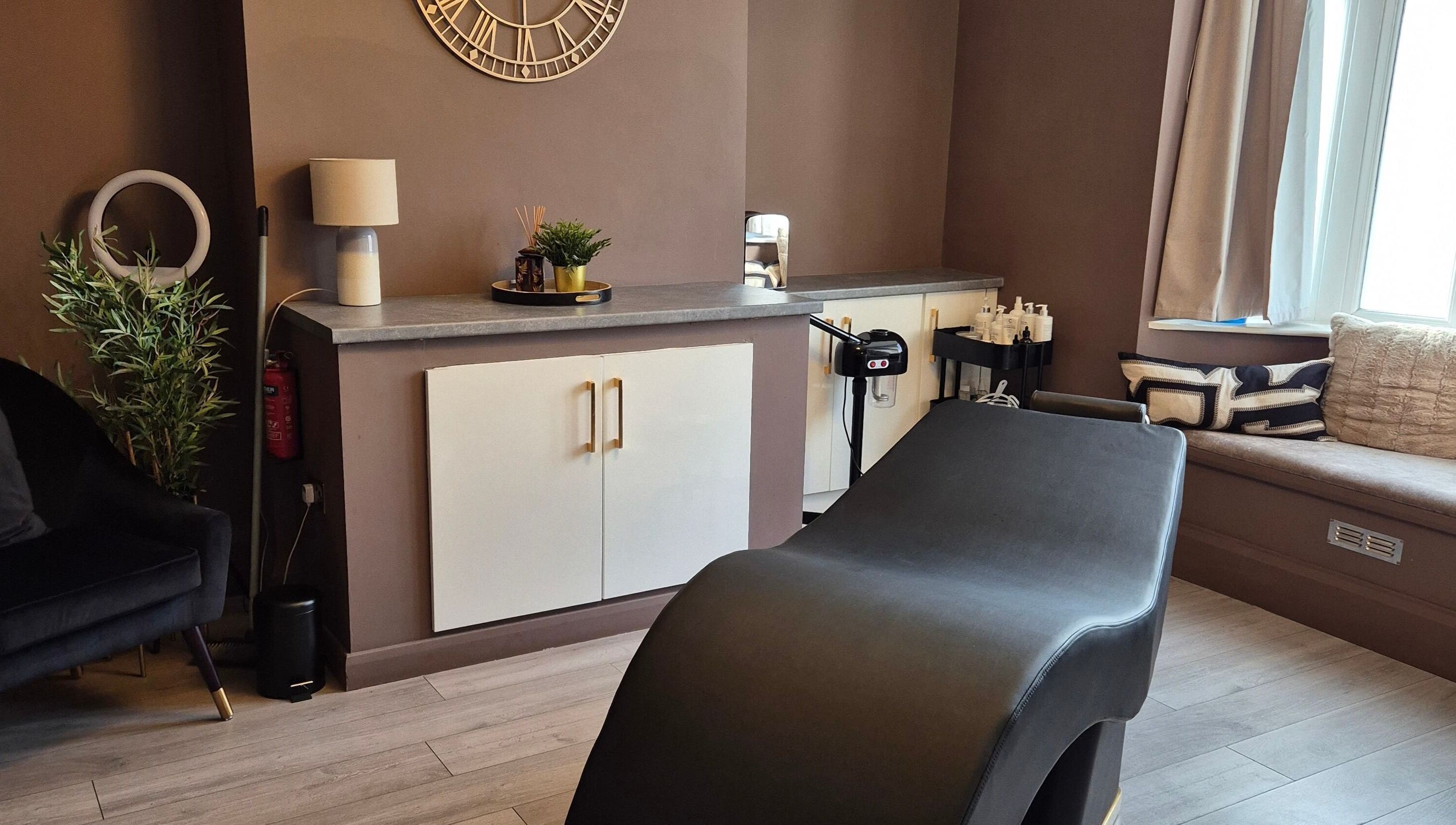 Relaxing treatment room at Skin Deep Beauty Room, Scunthorpe, England, GB featuring sleek decor and comfortable seating.