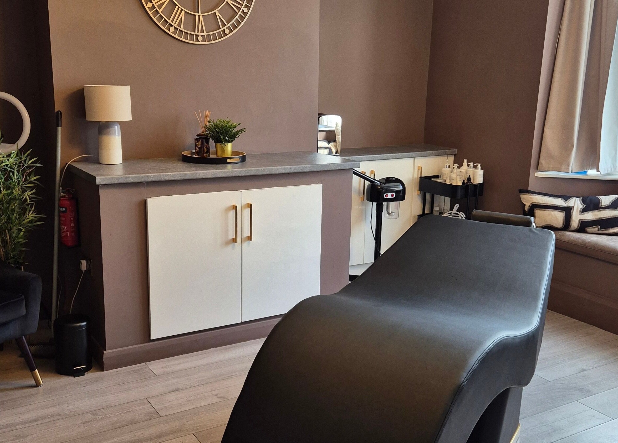 Relaxing treatment room at Skin Deep Beauty Room, Scunthorpe, England, GB featuring sleek decor and comfortable seating.