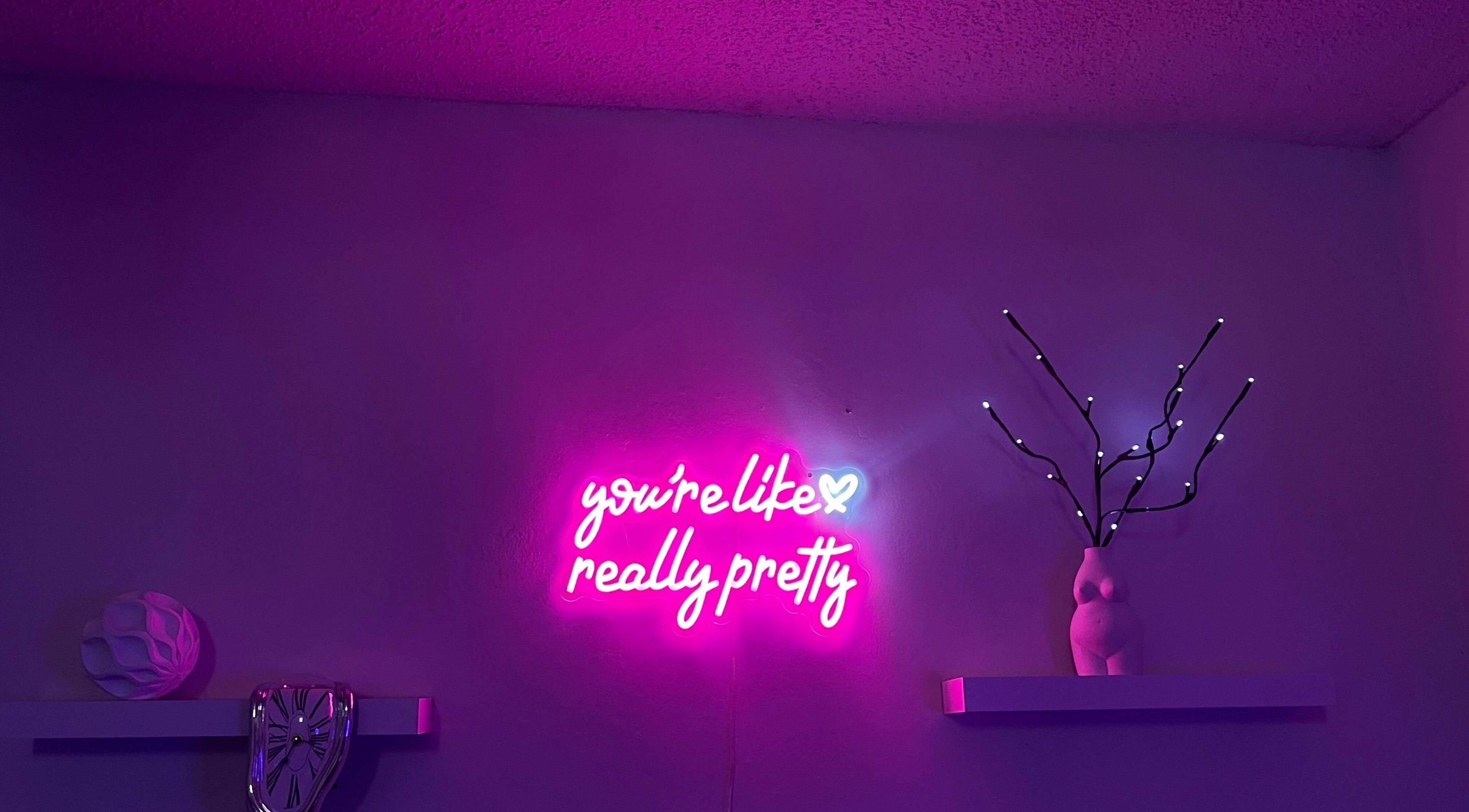 XO Beauty Wax's vibrant neon sign and decor in San Bernardino, California, US, creating a stylish ambiance.