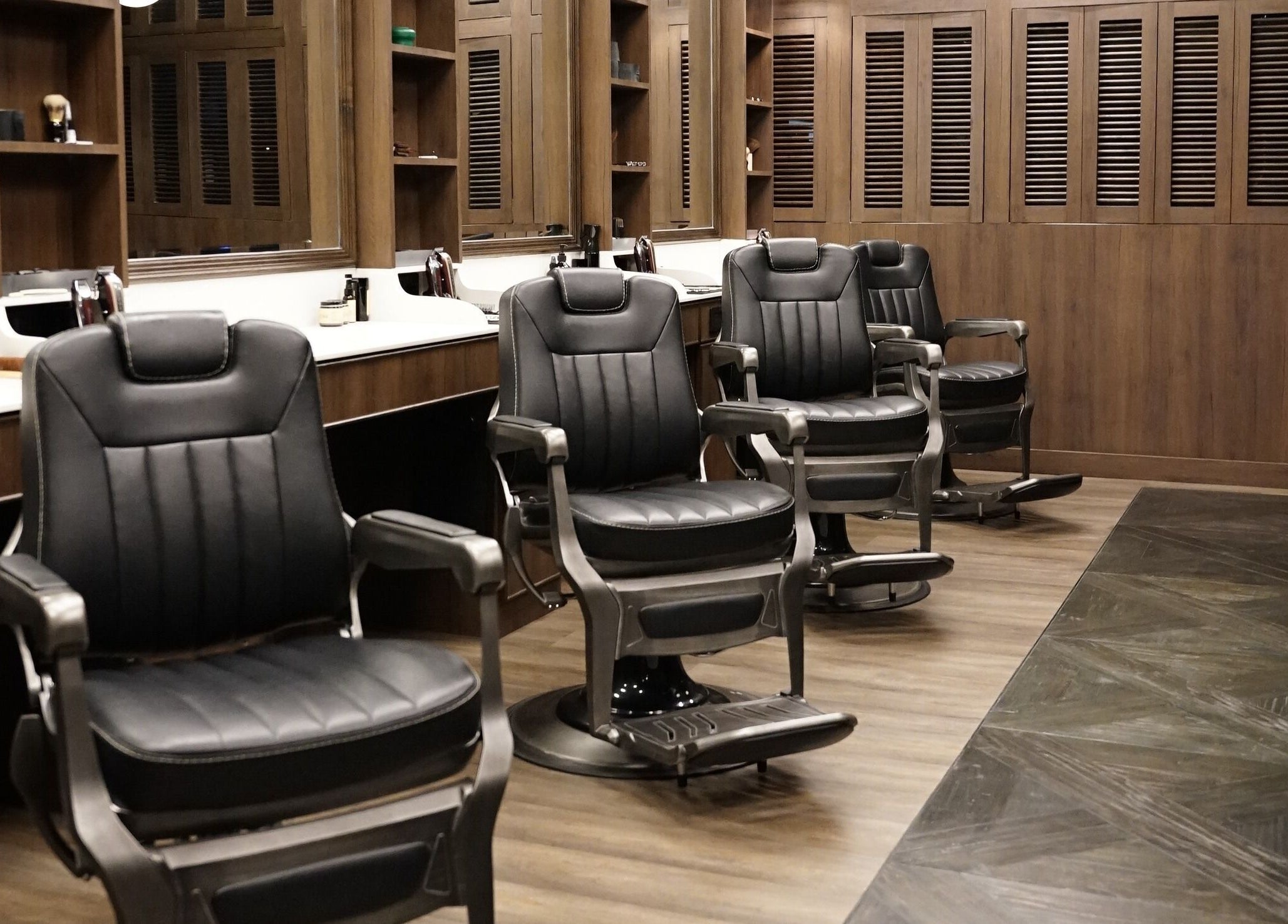 Modern barber chairs at The Barber Bar, Daerah Khusus Ibukota Jakarta, inviting for stylish grooming.