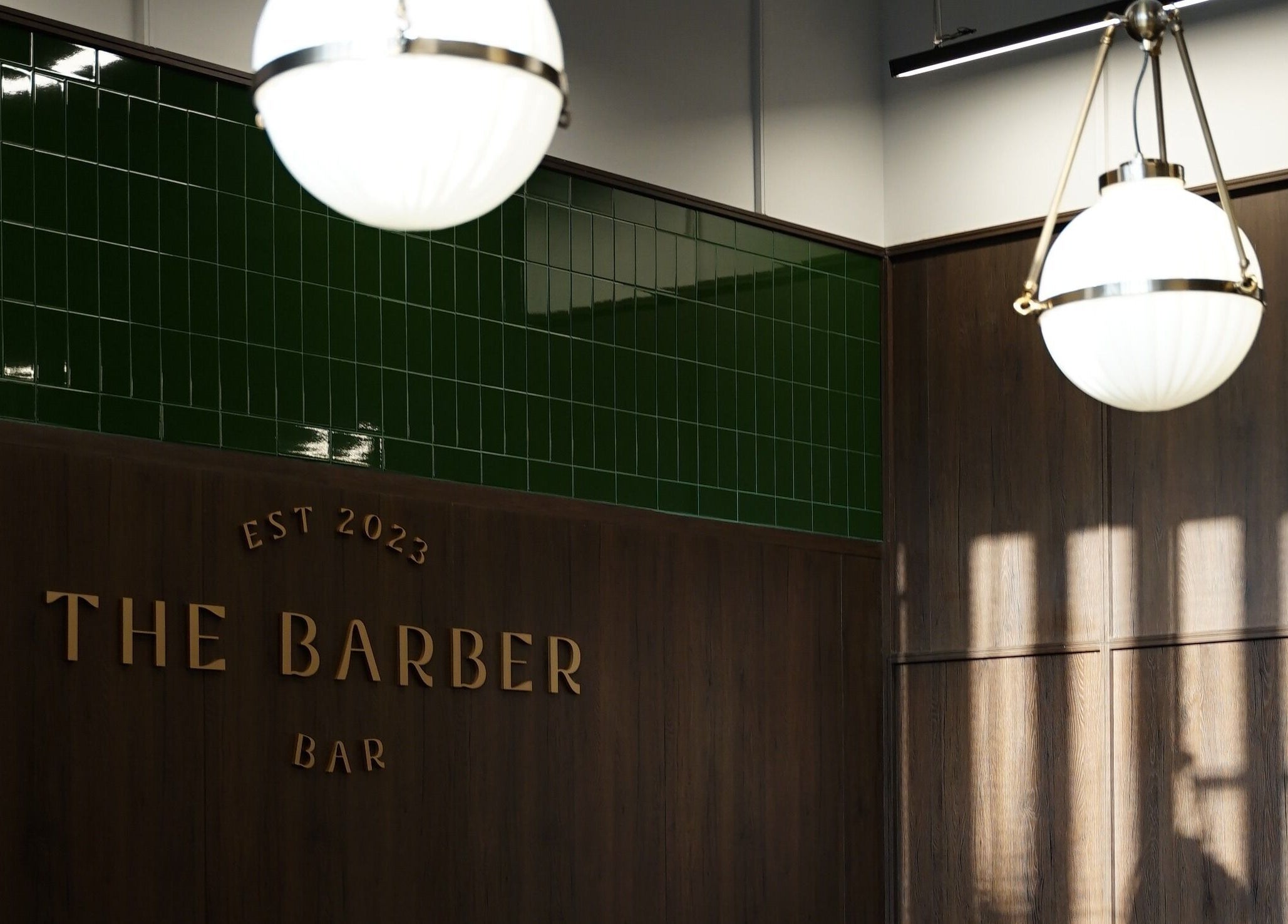Elegant interior of The Barber Bar in Daerah Khusus Ibukota Jakarta with modern lighting and decor.