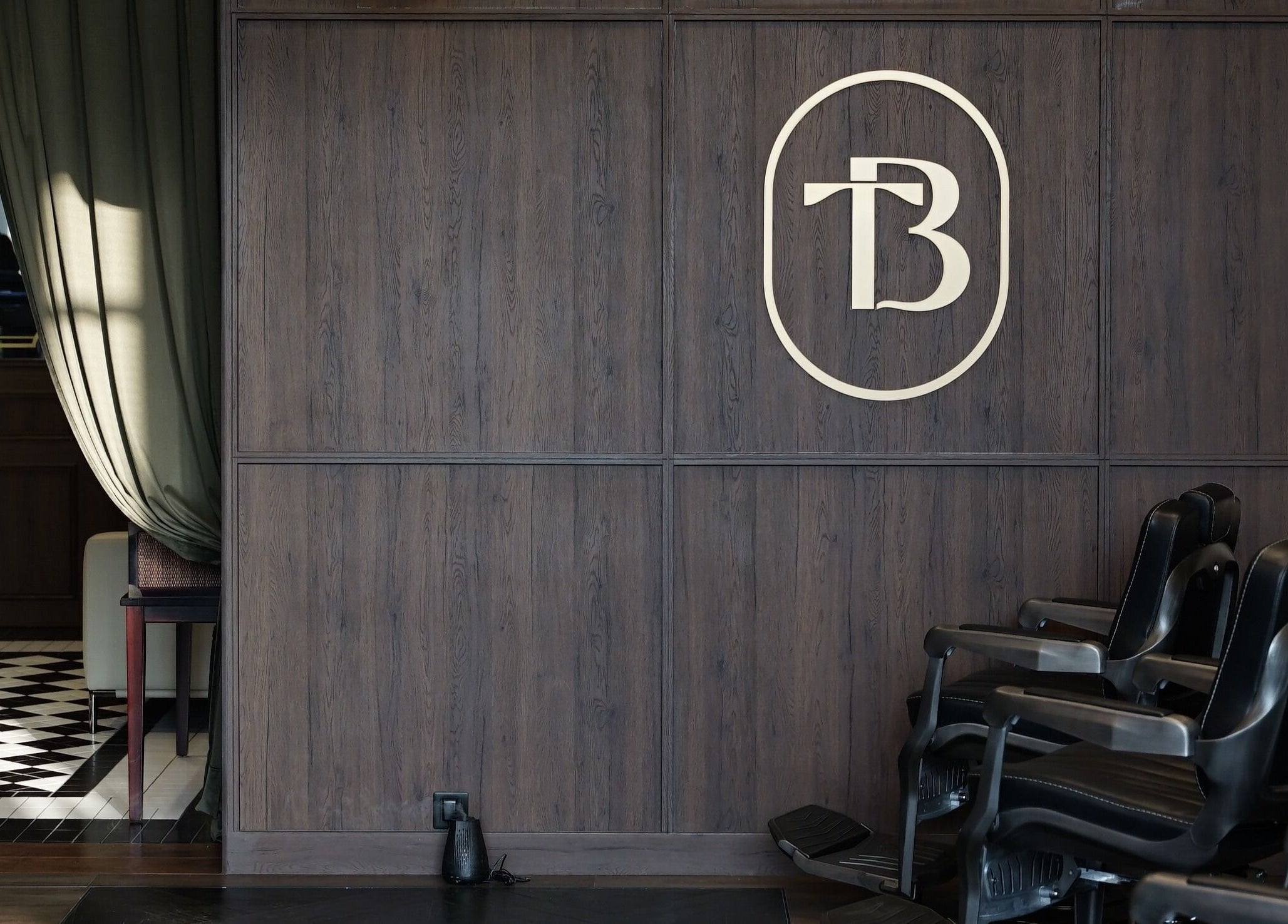 Interior of The Barber Bar in Daerah Khusus Ibukota Jakarta featuring sleek chairs and stylish decor.