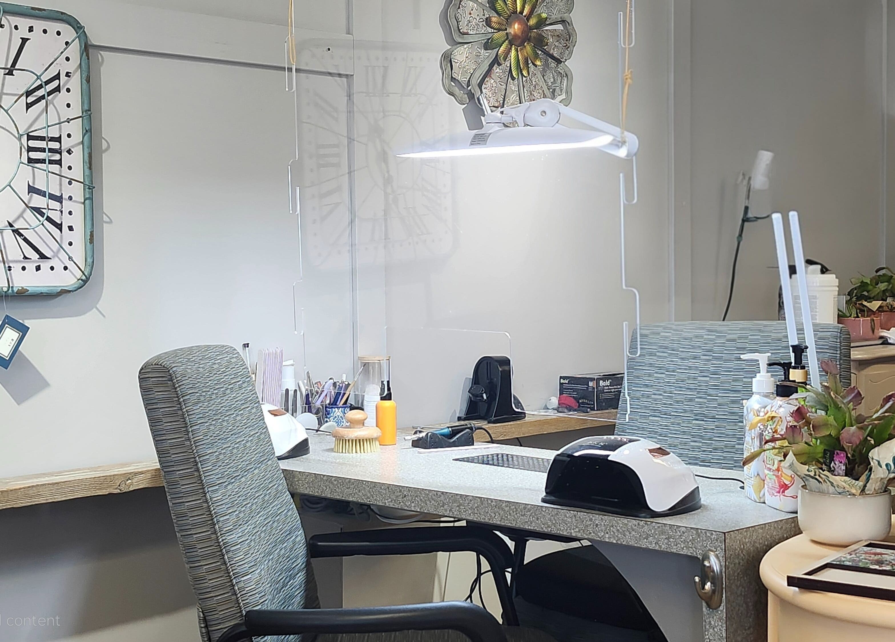 Cozy manicure station at Total Esthetics, Spruce Grove, Alberta, CA, featuring elegant decor and skincare products.