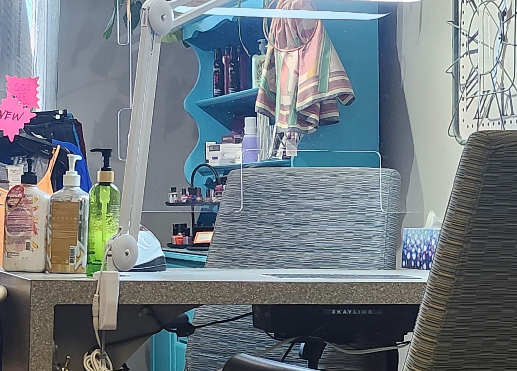 View of a stylish manicure station at Total Esthetics in Spruce Grove, Alberta, CA showcasing salon products.