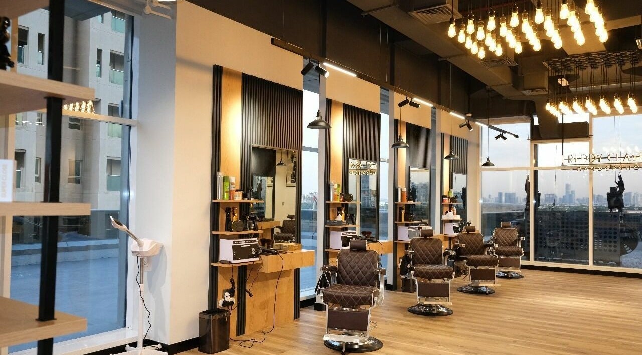 Chic interior of FreddyClassics Barbershop, Dubai, Dubai, AE, with luxury leather chairs and modern decor.