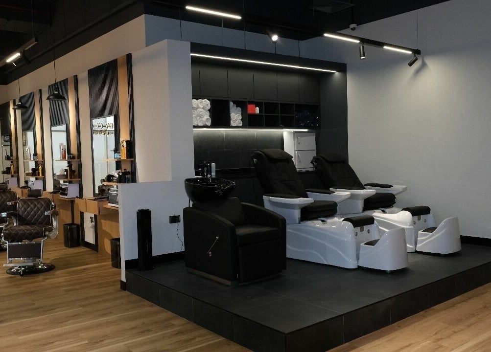 Chic interior of FreddyClassics Barbershop in Dubai, Dubai, AE, with modern styling chairs and sleek décor.