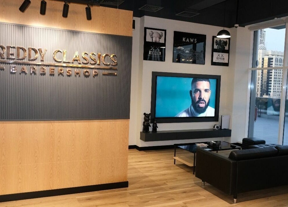 FreddyClassics Barbershop interior with wooden decor and city view in Dubai, Dubai, AE.