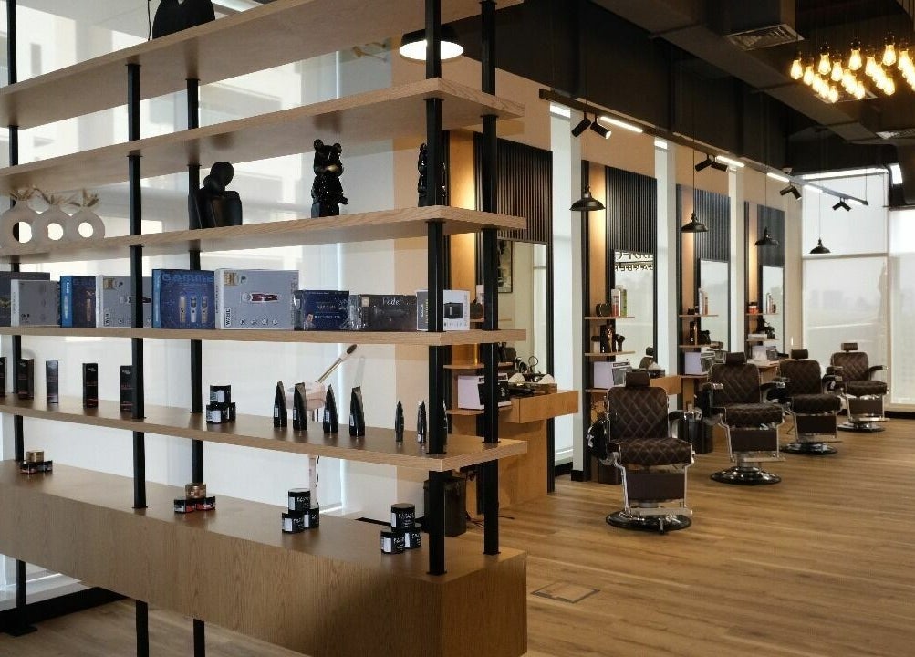 Modern interior of FreddyClassics Barbershop in Dubai, Dubai, AE, featuring barber chairs and stylish decor.