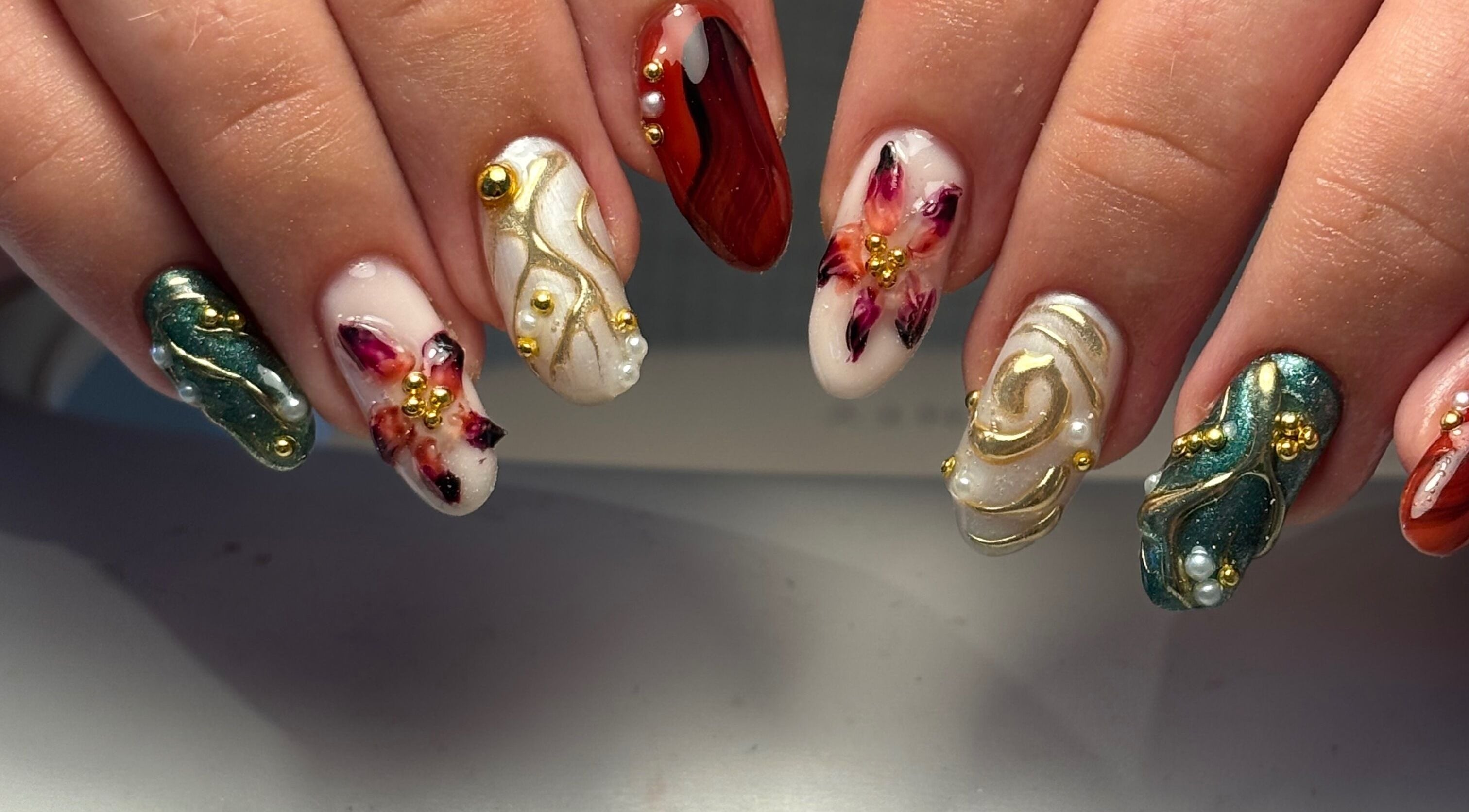 Intricate nail art design at Salon 31 by Rosie, Heath And Reach, England, GB showcases floral and gold accents.