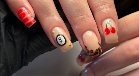 Intricate nail art at Salon 31 by Rosie, Heath And Reach, England, GB, featuring vibrant cherry and leopard designs.