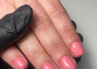Bright pink manicure at Beauty Therapist by Charlotte, Kegworth, England, GB, showcasing glossy nail finish.