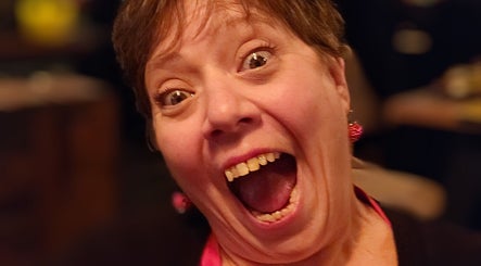 Excited woman at Hair By Tory in Stowmarket, England, GB, showcasing her happiness.