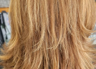 Beautiful layered hairstyle at Hair By Tory, Stowmarket, England, GB showcasing golden blonde highlights.