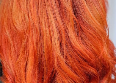 Vibrant orange hair styling by Hair By Tory in Stowmarket, England, GB, showcasing rich, bold color treatment.