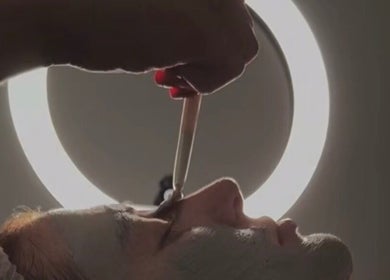 Facial treatment in progress at SKNFORM, Newton-le-willows, England, GB under soft lighting.