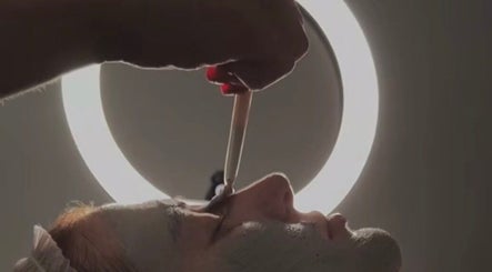 Facial treatment in progress at SKNFORM, Newton-le-willows, England, GB under soft lighting.