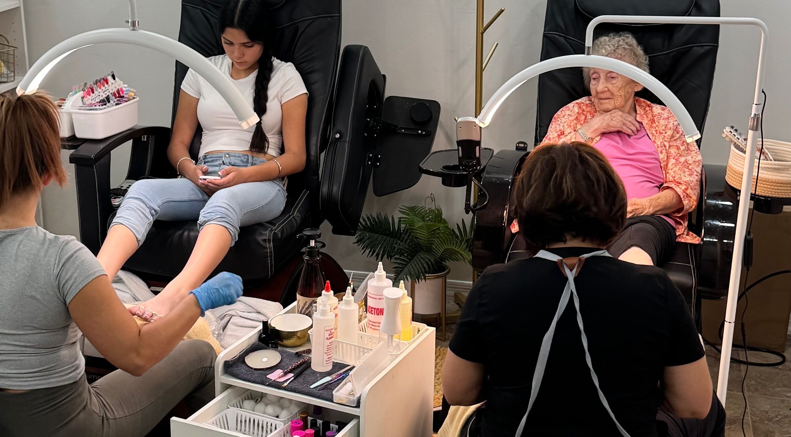 Two women receiving pedicures at House of Pedi’s by Lydia in Tucson, Arizona, US. Comfortable spa chairs enhance the experience.