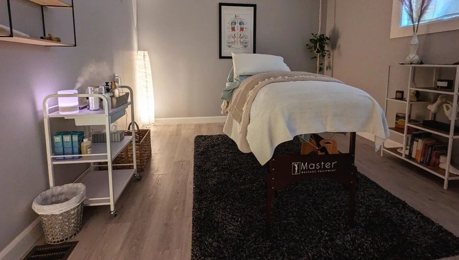 Peaceful massage room at The Celestial Root, Belleville, Ontario, CA featuring a neatly arranged treatment table.