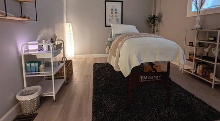 Peaceful massage room at The Celestial Root, Belleville, Ontario, CA featuring a neatly arranged treatment table.
