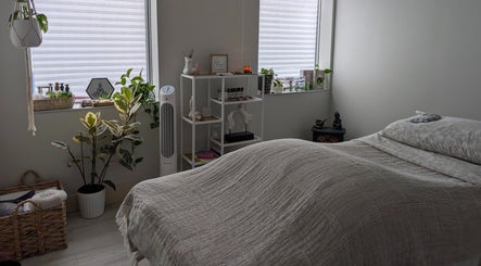 Calm treatment room at The Celestial Root, Belleville, Ontario, CA, featuring serene decor and wellness elements.