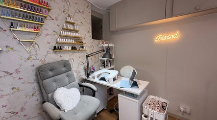Mai Nails and Lash Studio's stylish nail station in London, England, GB with polish display and cozy chair.