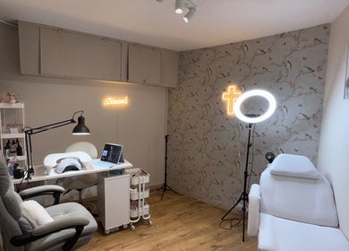 Mai Nails and Lash Studio, London, England, GB. Cozy interior with plush chair, nail table, and warm lighting.