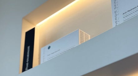 Skincare products on illuminated shelf at Skulptured Skin & Body, Ropes Crossing, New South Wales, AU.