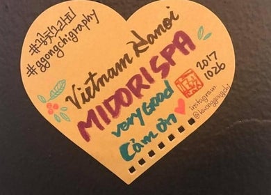 Handwritten note praising Midori Spa Hanoi at Hà Nội, Hà Nội, VN, with decorative accents.