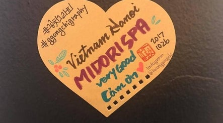 Handwritten note praising Midori Spa Hanoi at Hà Nội, Hà Nội, VN, with decorative accents.