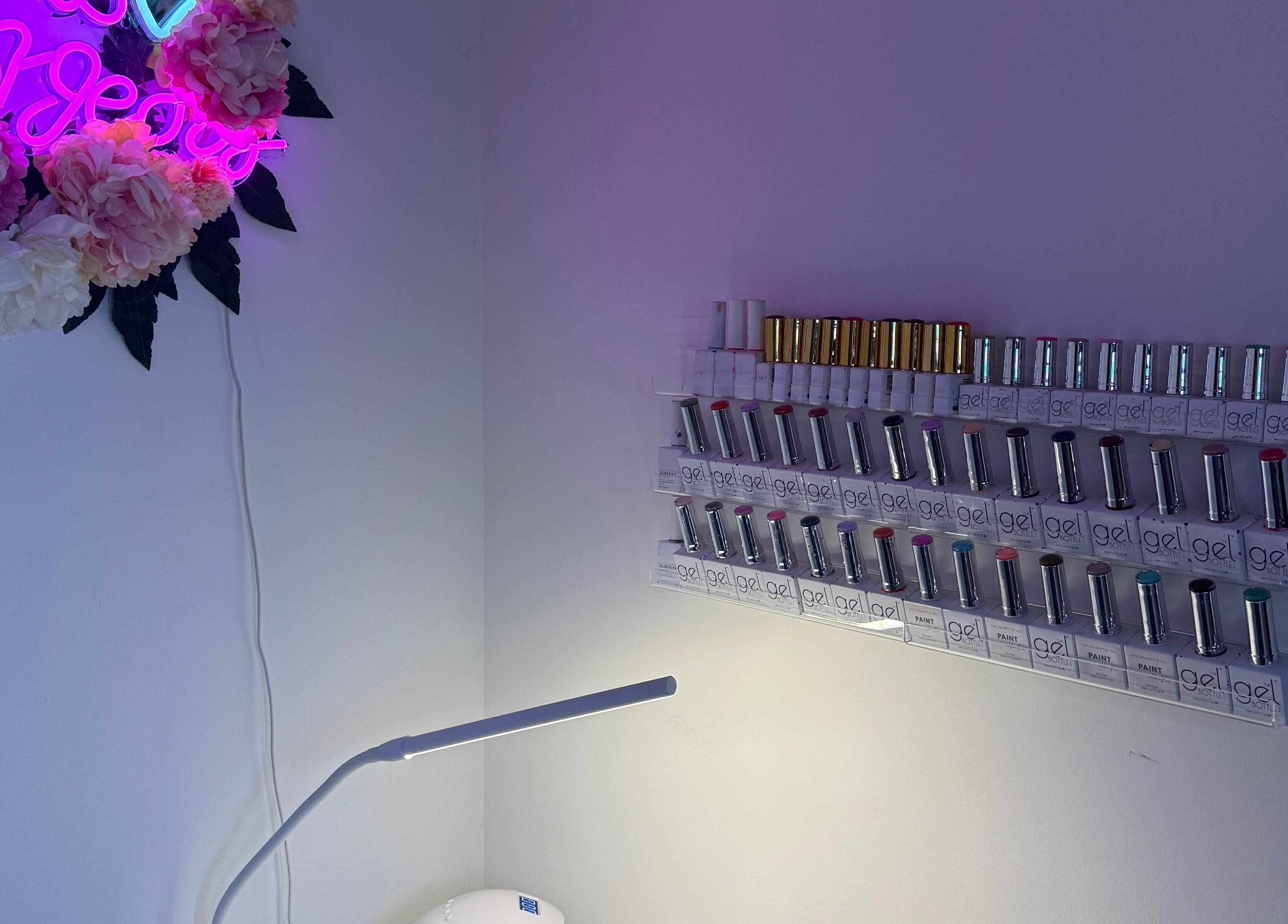 Nail polish shelf and floral neon sign at Beauty With Katie in Rosyth, Scotland, GB.