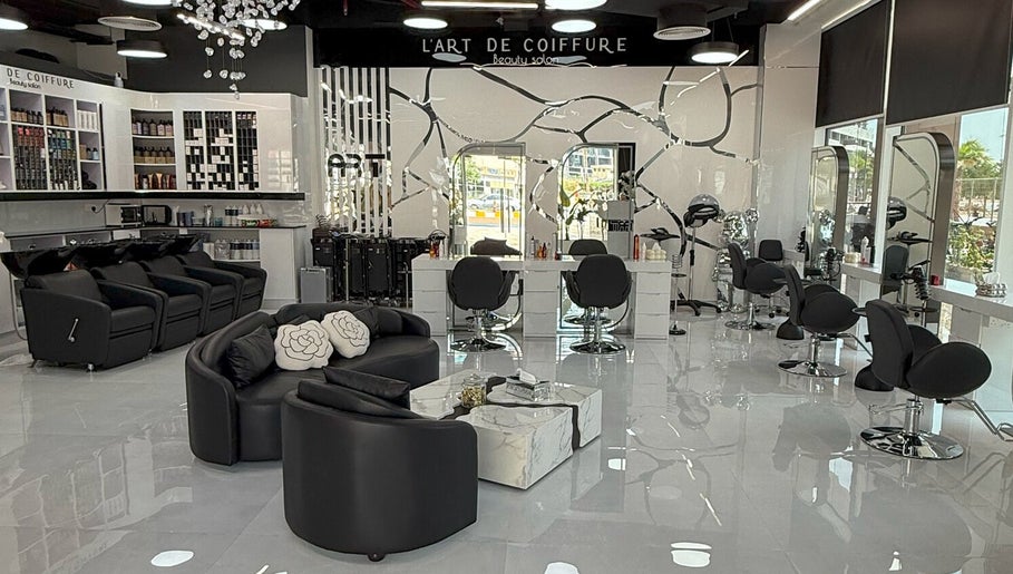 Interior of L'Art de Coiffure Salon in Dubai; modern chairs and bright atmosphere enhance its elegance.