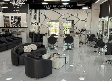 Interior of L'Art de Coiffure Salon in Dubai; modern chairs and bright atmosphere enhance its elegance.