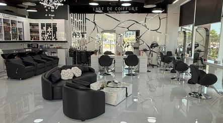 Interior of L'Art de Coiffure Salon in Dubai; modern chairs and bright atmosphere enhance its elegance.
