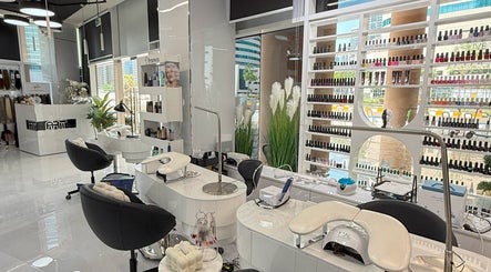 Modern interior of L'Art de Coiffure Salon in Dubai, AE, featuring elegant styling stations and product displays.