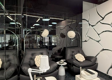 Chic lounge chairs in L'Art de Coiffure Salon, Dubai, Dubai, AE with modern decor accents.