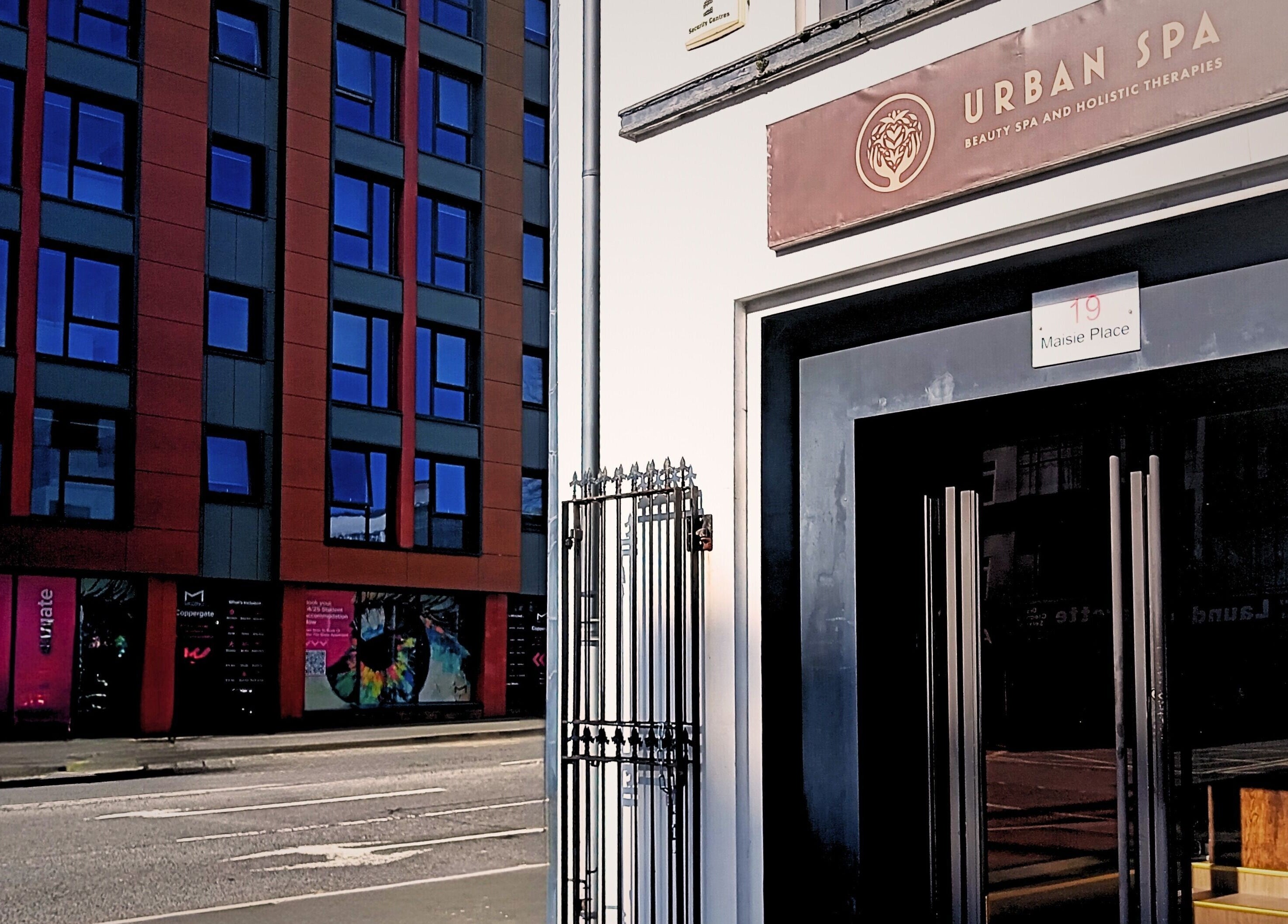 Entrance of Essential Bodywork by Sara Colautti at Swansea, Wales, GB opposite modern blue glass building.