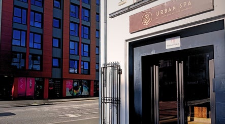 Entrance of Essential Bodywork by Sara Colautti at Swansea, Wales, GB opposite modern blue glass building.