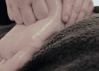 Foot massage at Essential Bodywork by Sara Colautti, Swansea, Wales, GB, showcasing relaxation and care.