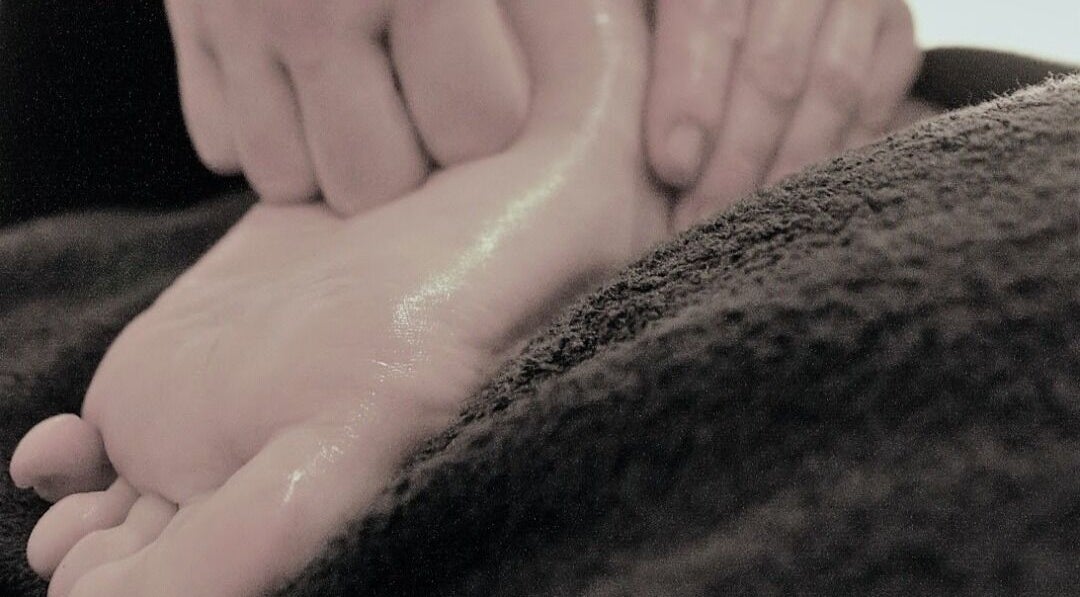 Foot massage at Essential Bodywork by Sara Colautti, Swansea, Wales, GB, showcasing relaxation and care.