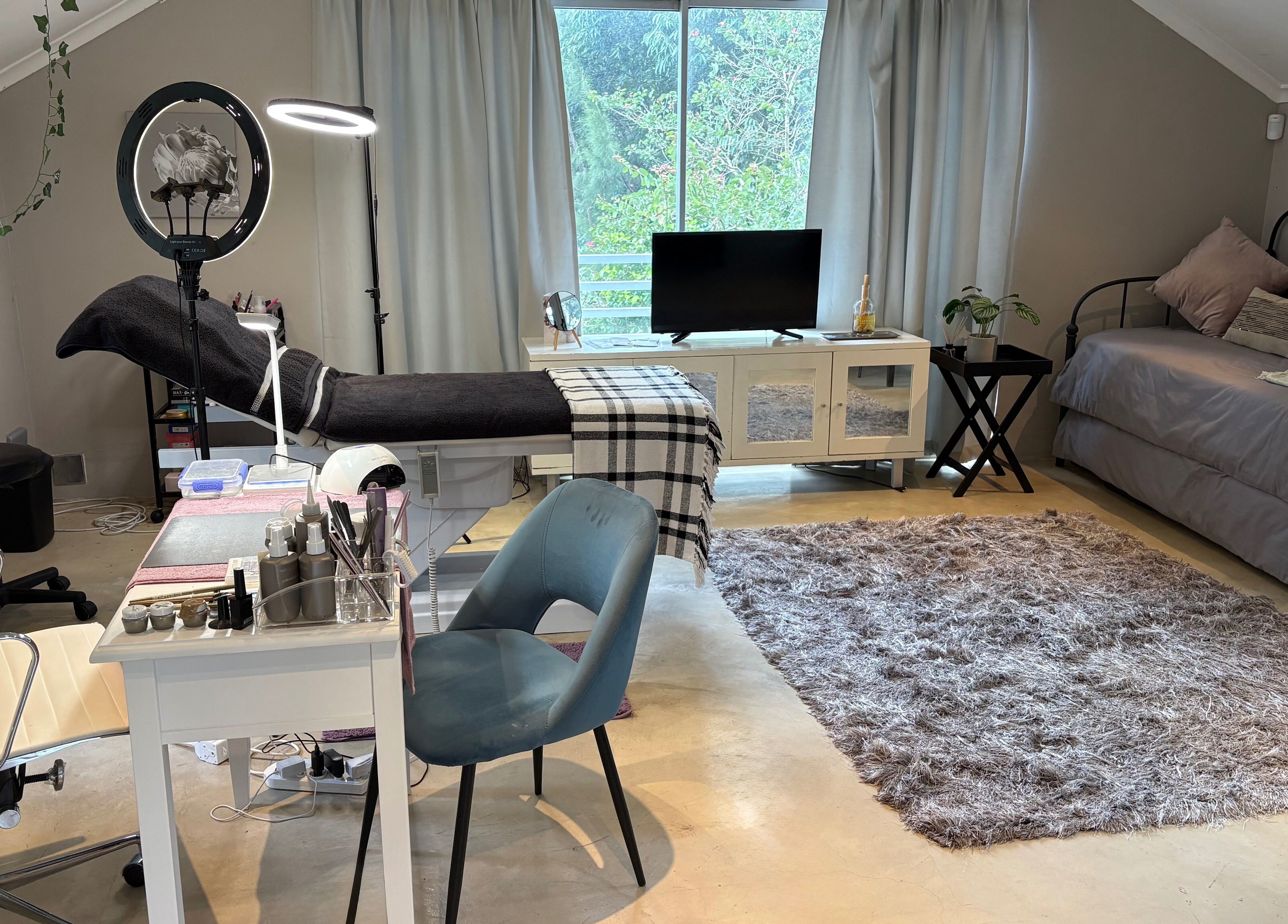 Karmi's beauty treatment room in Somerset West, Western Cape, ZA, featuring plush seating and a serene atmosphere.