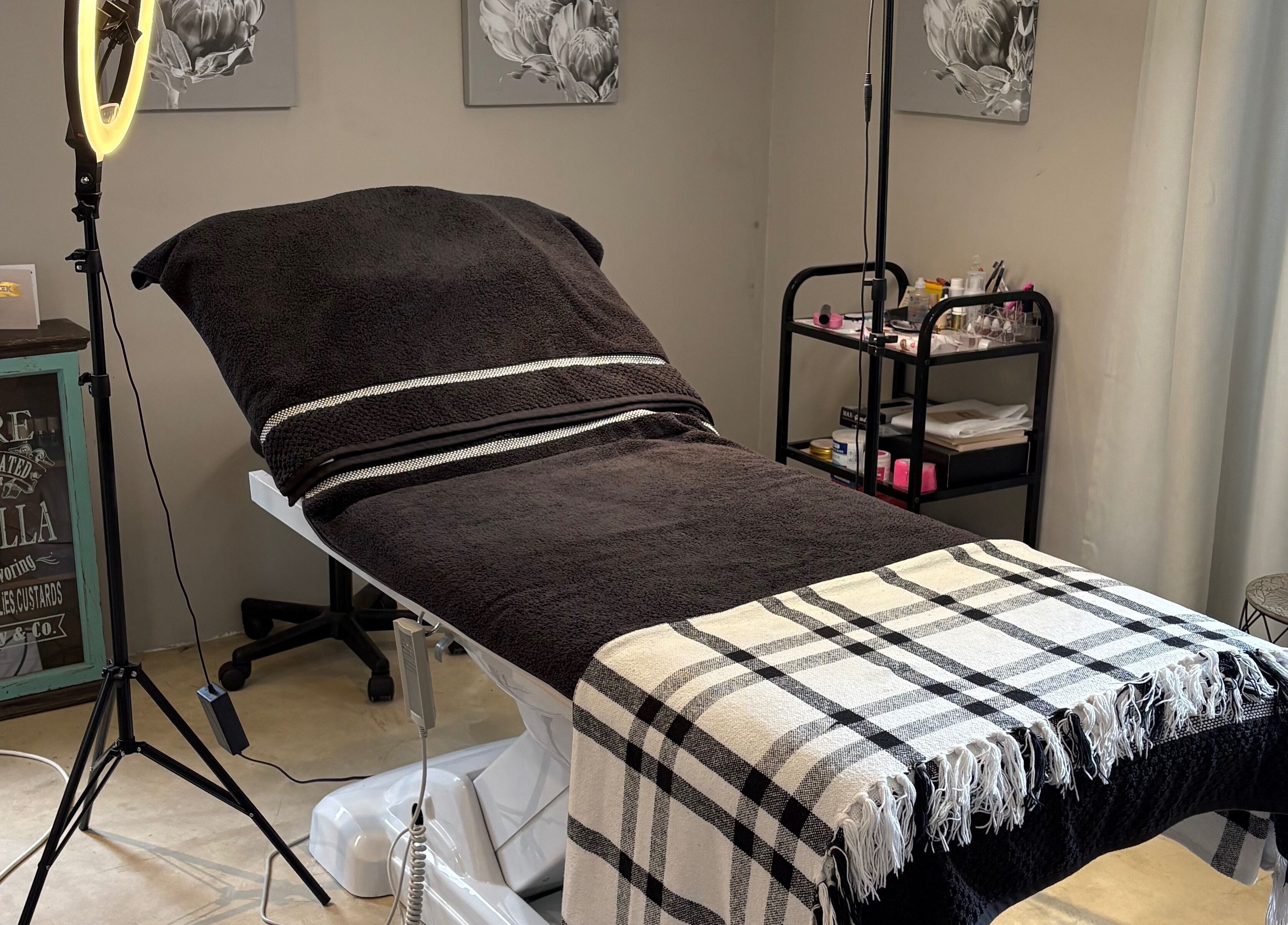 Cozy treatment room at Karmi in Somerset West, Western Cape, ZA, featuring a massage bed and warm lighting.
