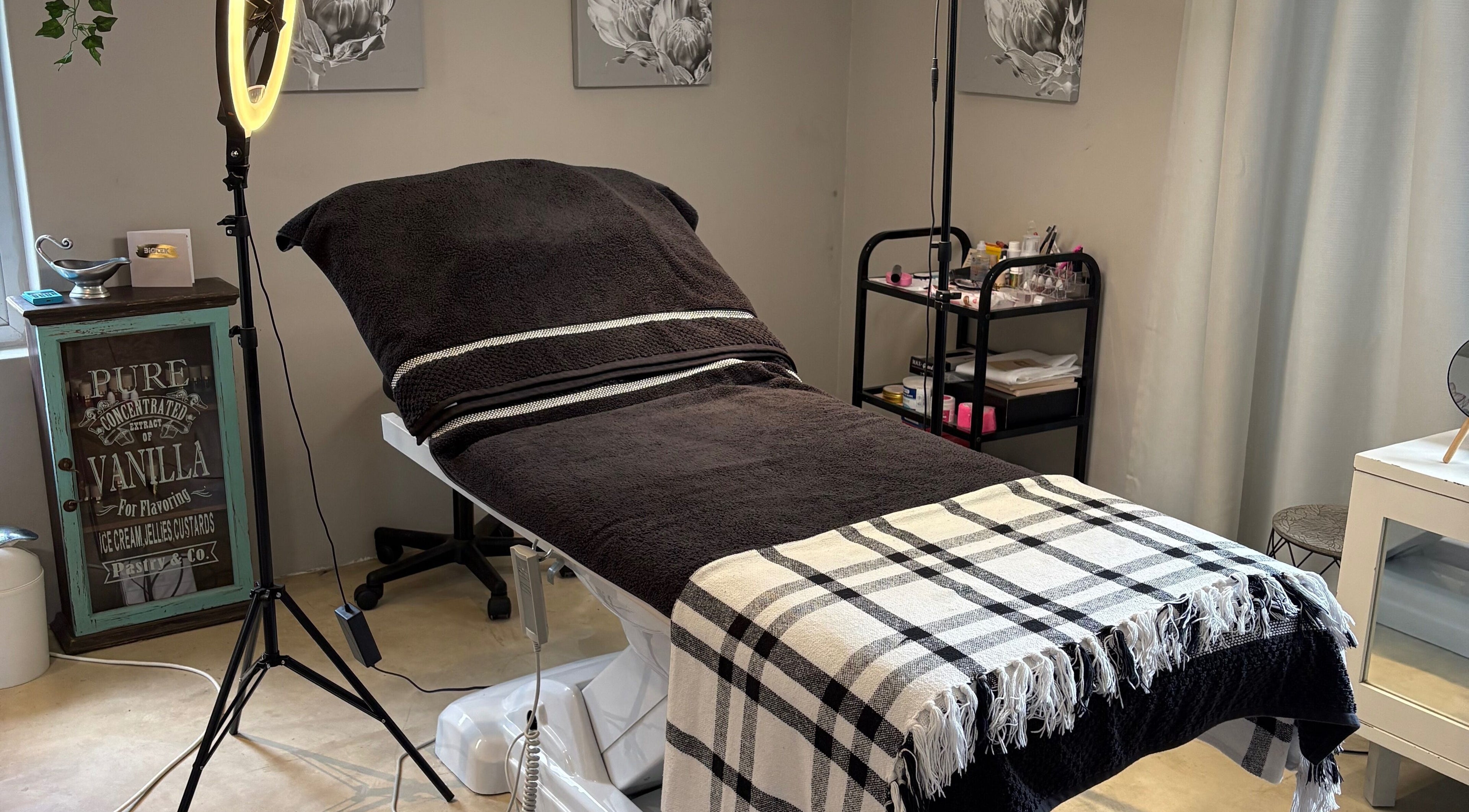 Cozy treatment room at Karmi in Somerset West, Western Cape, ZA, featuring a massage bed and warm lighting.