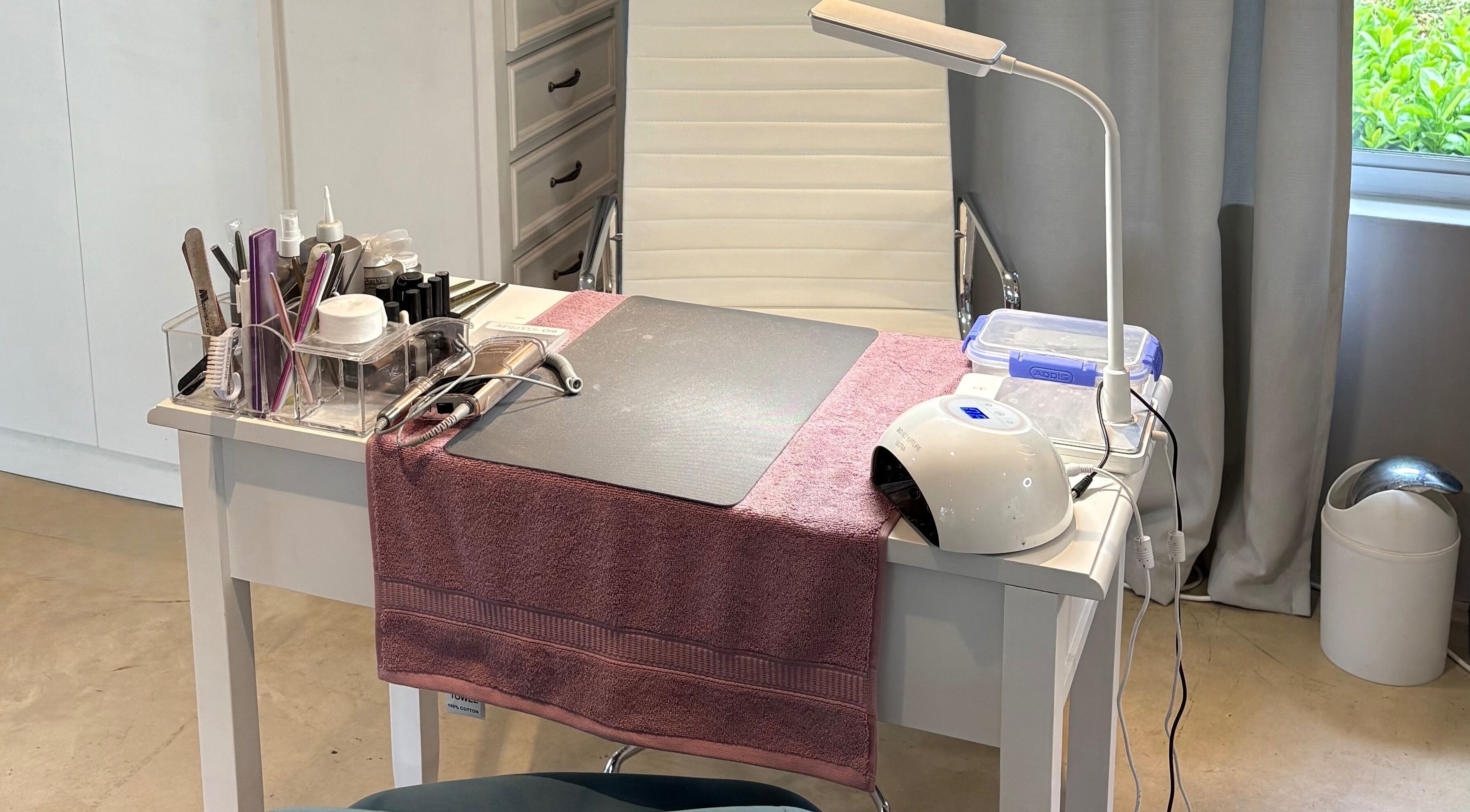 Manicure station at Karmi, Somerset West, Western Cape, ZA, showcasing tools and a cozy setup.