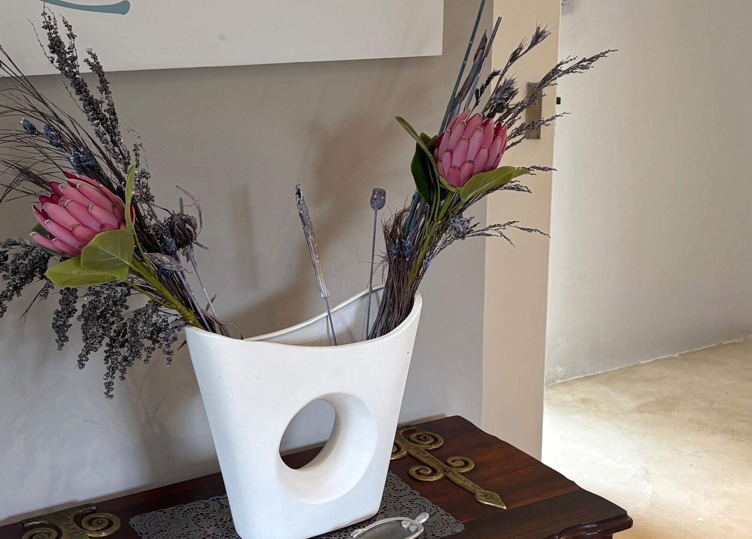 Elegant floral arrangement in a modern vase at Karmi, Somerset West, Western Cape, ZA.