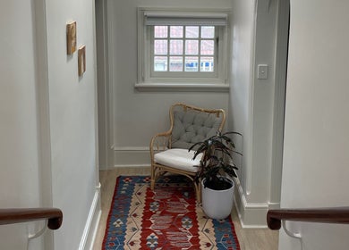 Relaxing seating area with chair and plant at Restoree | Holistic Remedial Massage, Bondi, New South Wales, AU.