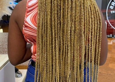 Long golden braids hairstyle at Aurora Beauty Bay, Accra, Greater Accra Region, GH, showcasing stunning craftsmanship.