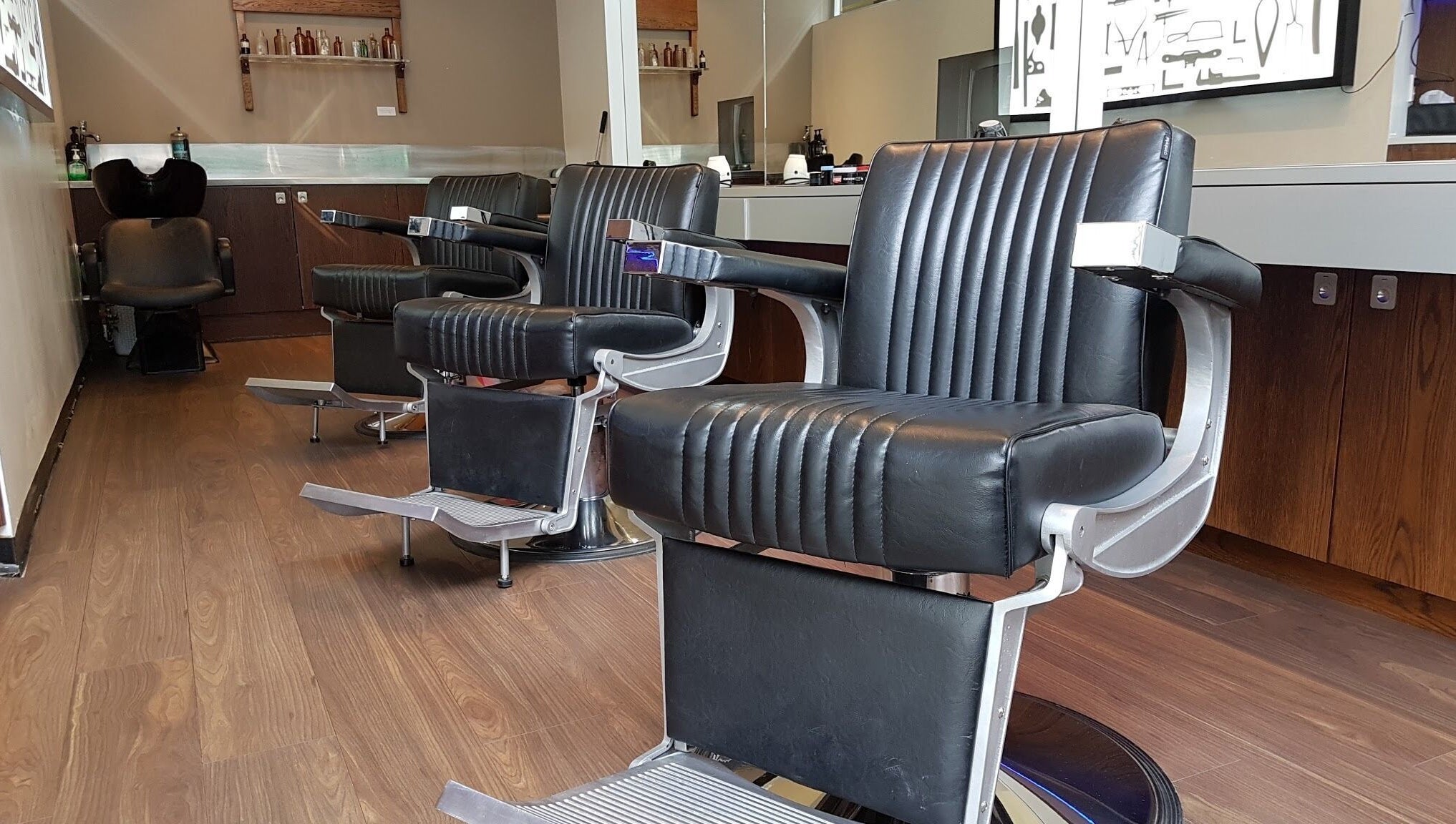 Chic black barber chairs at The Gentry - Shortland Street, Auckland, Auckland, NZ, offering luxury grooming services.