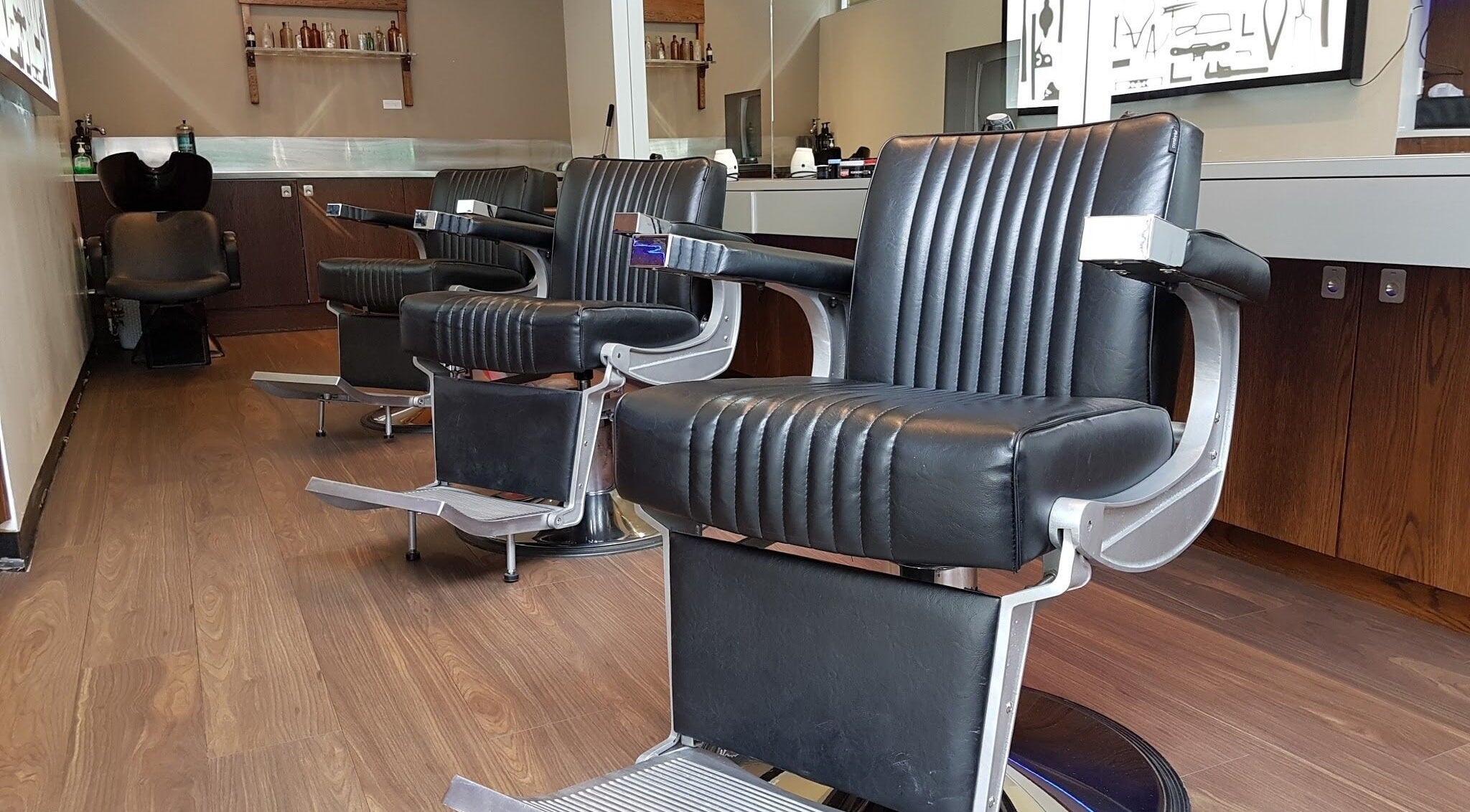 Chic black barber chairs at The Gentry - Shortland Street, Auckland, Auckland, NZ, offering luxury grooming services.