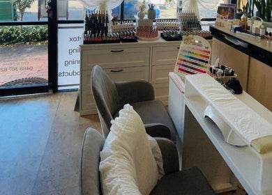 Cozy nail station at Aroma Nail and Beauty, East Brisbane, Queensland, AU with polish display.