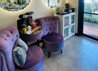 Inviting seating at Aroma Nail and Beauty, East Brisbane, Queensland, AU, with plush purple chairs and a tea setup.